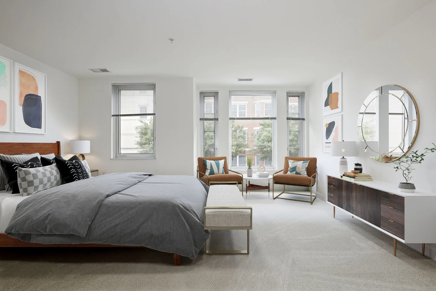 Bedroom with large bed, dresser, wall mirror and ample light